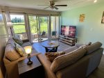 Living room with lots of seating and lanai that faces the golf course